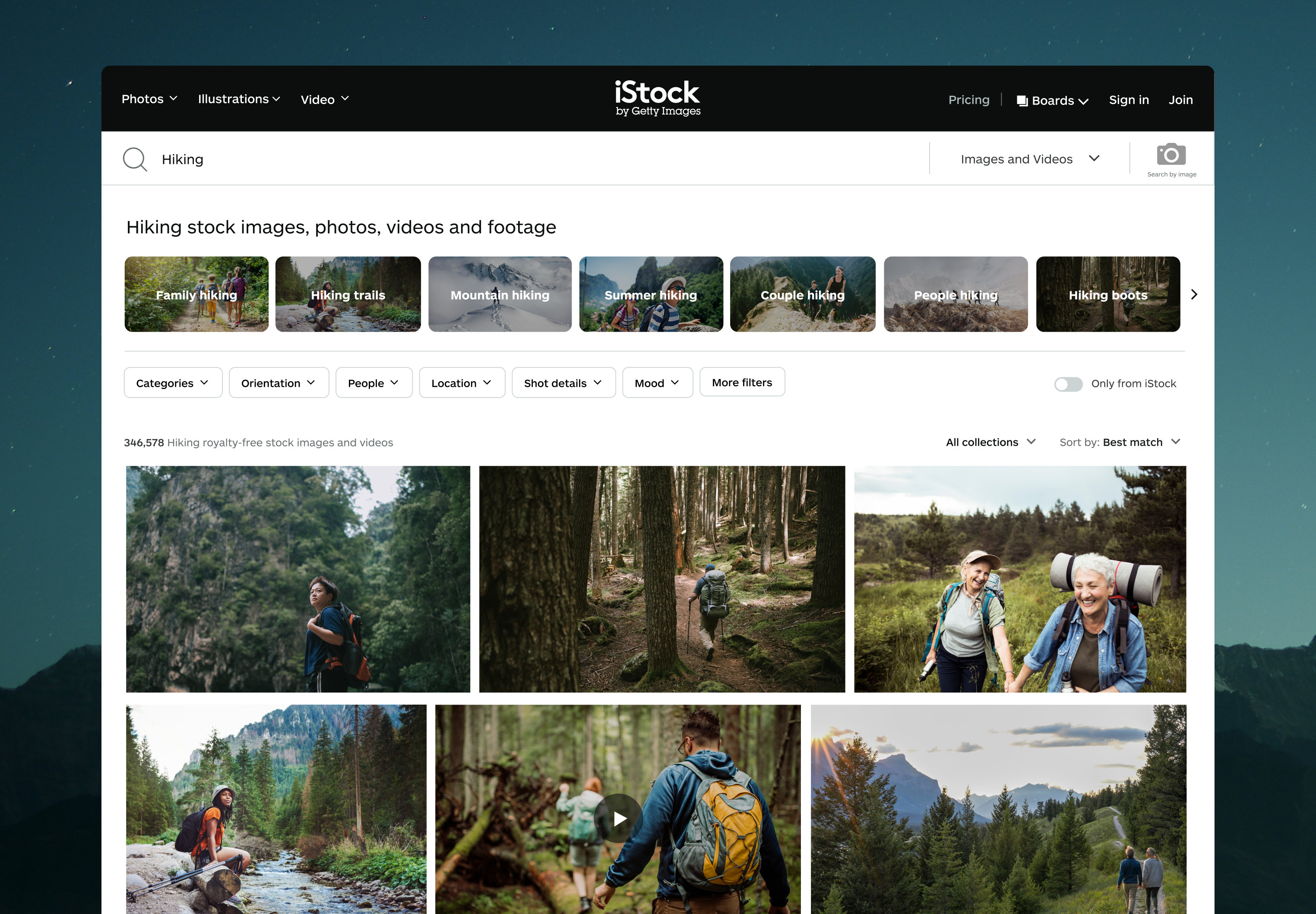 iStock video and image search results page for 'Hiking' showing mixed photo and video results with video play indicators in a masonry grid
